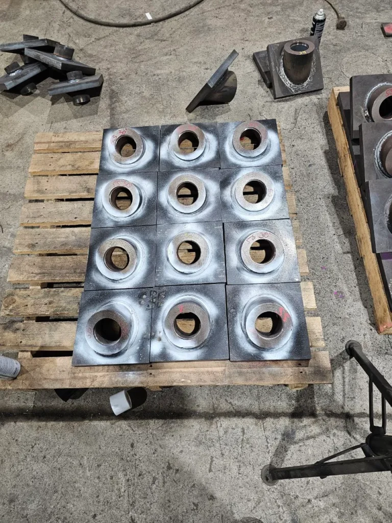 Welded steel plates laid out on a pallet after magnetic particle inspection