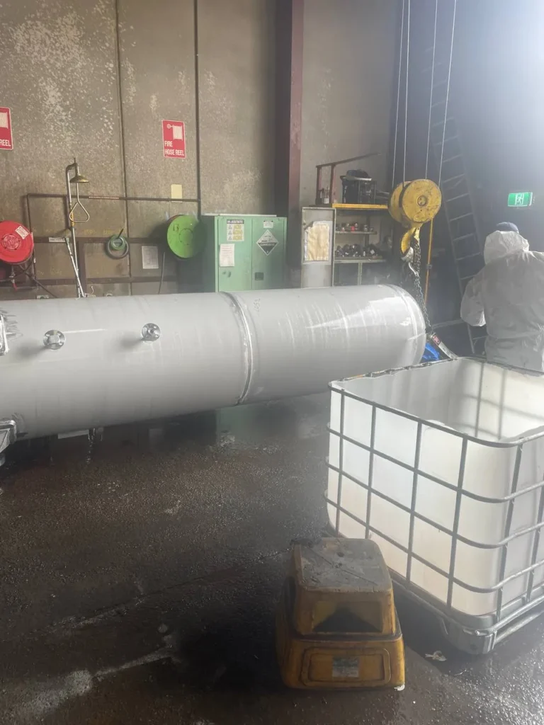 Painted pressure vessel in a workshop during in-process inspection
